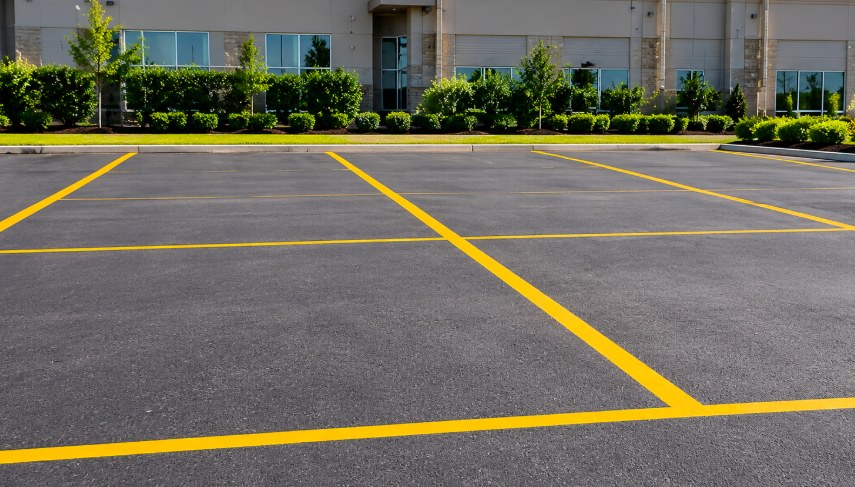 Level commercial parking lot with yellow lines